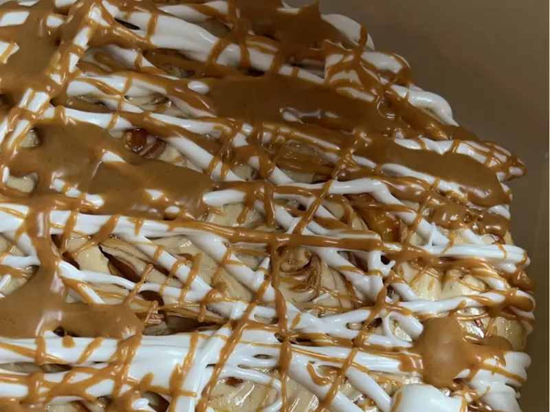 Cheesecake with white and brown icing by Diner's Choice Eats